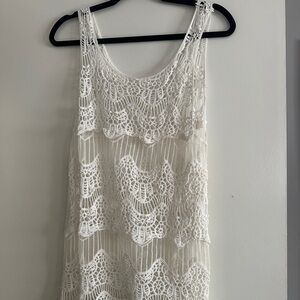 White lace crochet dress with a lace hem,